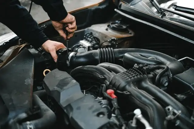 1 An Auto Mechanic Checking the Engine of a Car