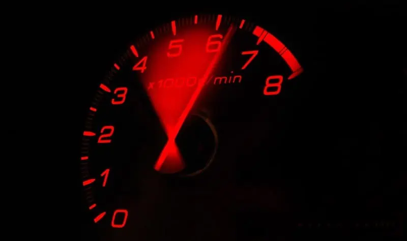 1. An analog tachometer showing the RPM of a vehicle