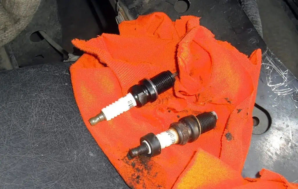 1. Old spark plug removed from a car new one ready to install 1