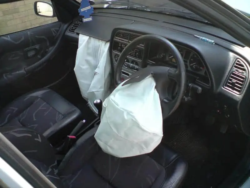 1. The driver and passenger front airbag modules after having been deployed