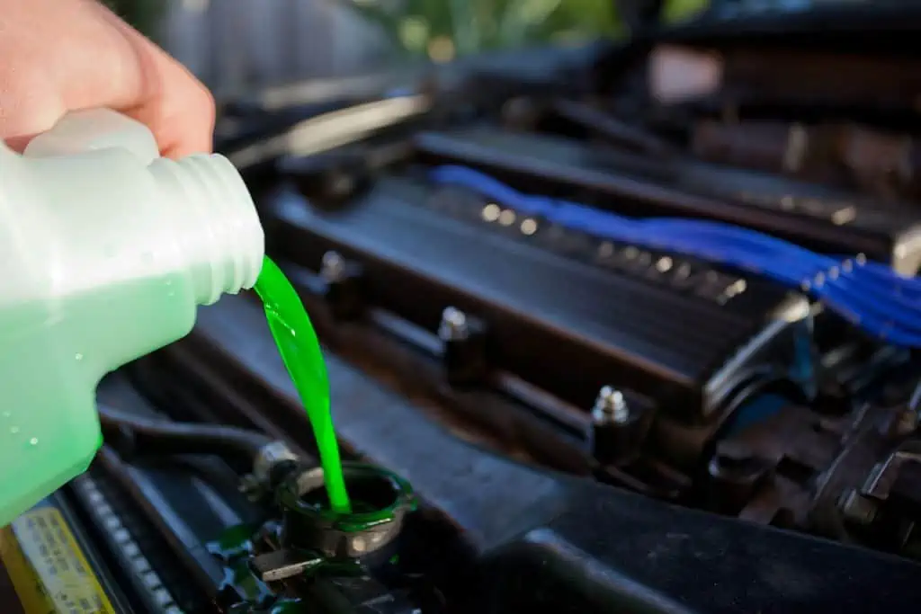 2. Coolant being poured into the radiator of an automobile