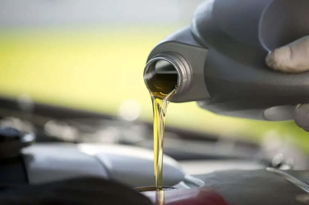 4. Fresh motor oil is poured into an engine