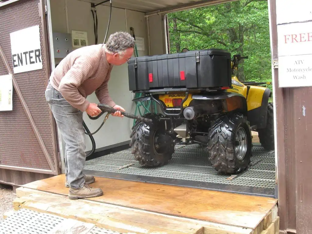 5. Rider cleaning an ATV