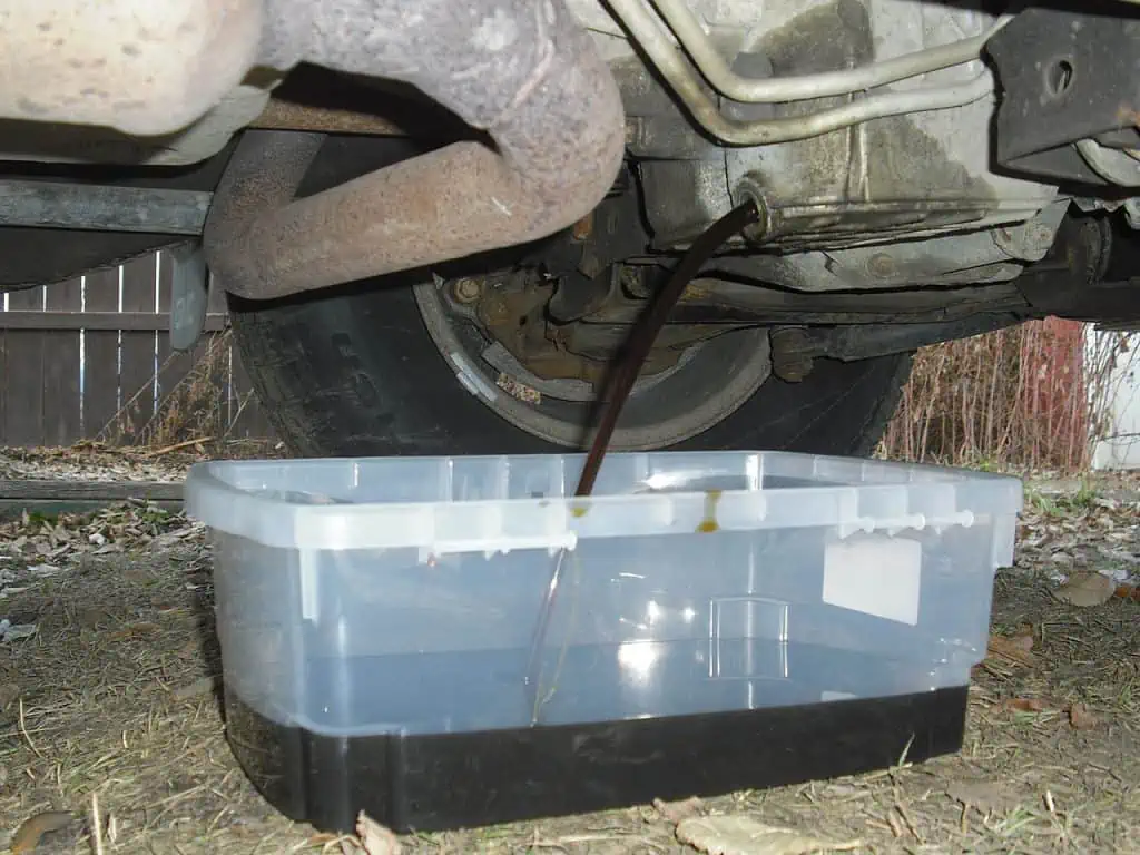 6. Oil being drained from a car into a drip pan