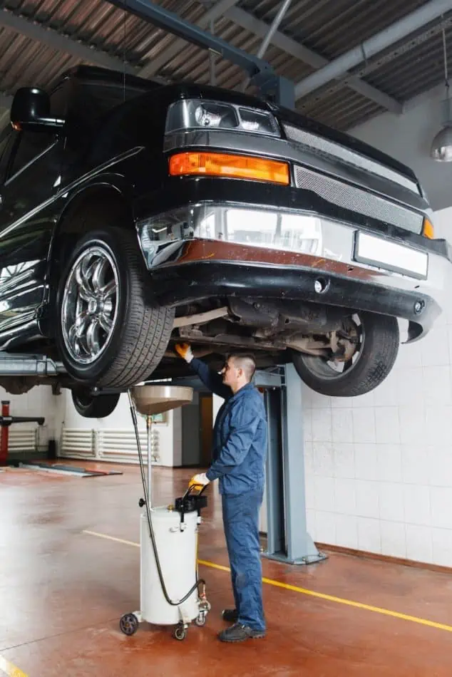 7. A trucks oil being drained at an oil change shop 1